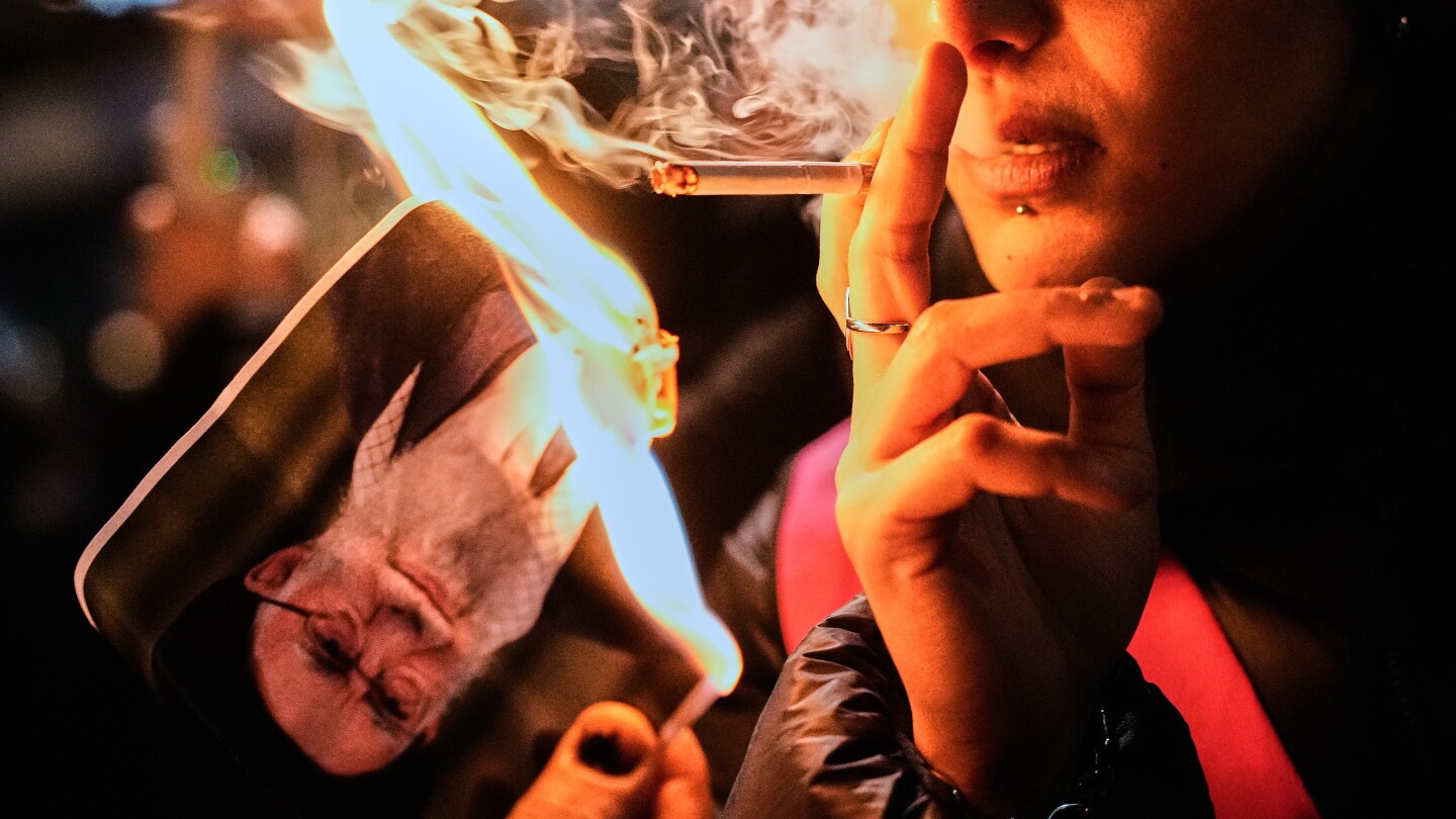 She speak photo afire, lit cigarette –